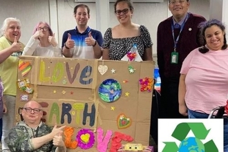 Green Superheroes smiling with their recycled arts and crafts