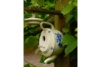 Upcycled teapot bird house 