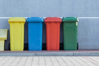 Photo of yellow, blue, red and green bins in a line