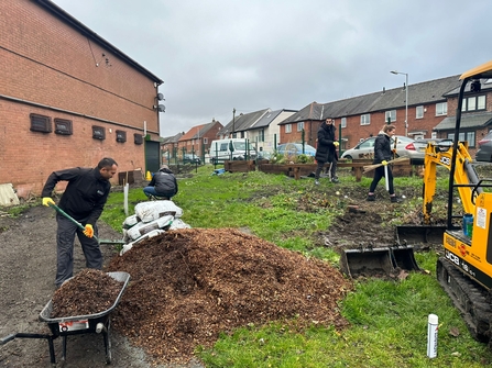 Members of Deane & Derby Cricket Club digging and improving their community garden, funded by the Green Spaces Fund