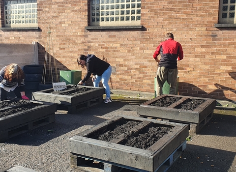 Volunteers planting at the Leigh Community Garden