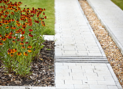 Walkway in an estate in West Gorton transformed with grass and flowers.